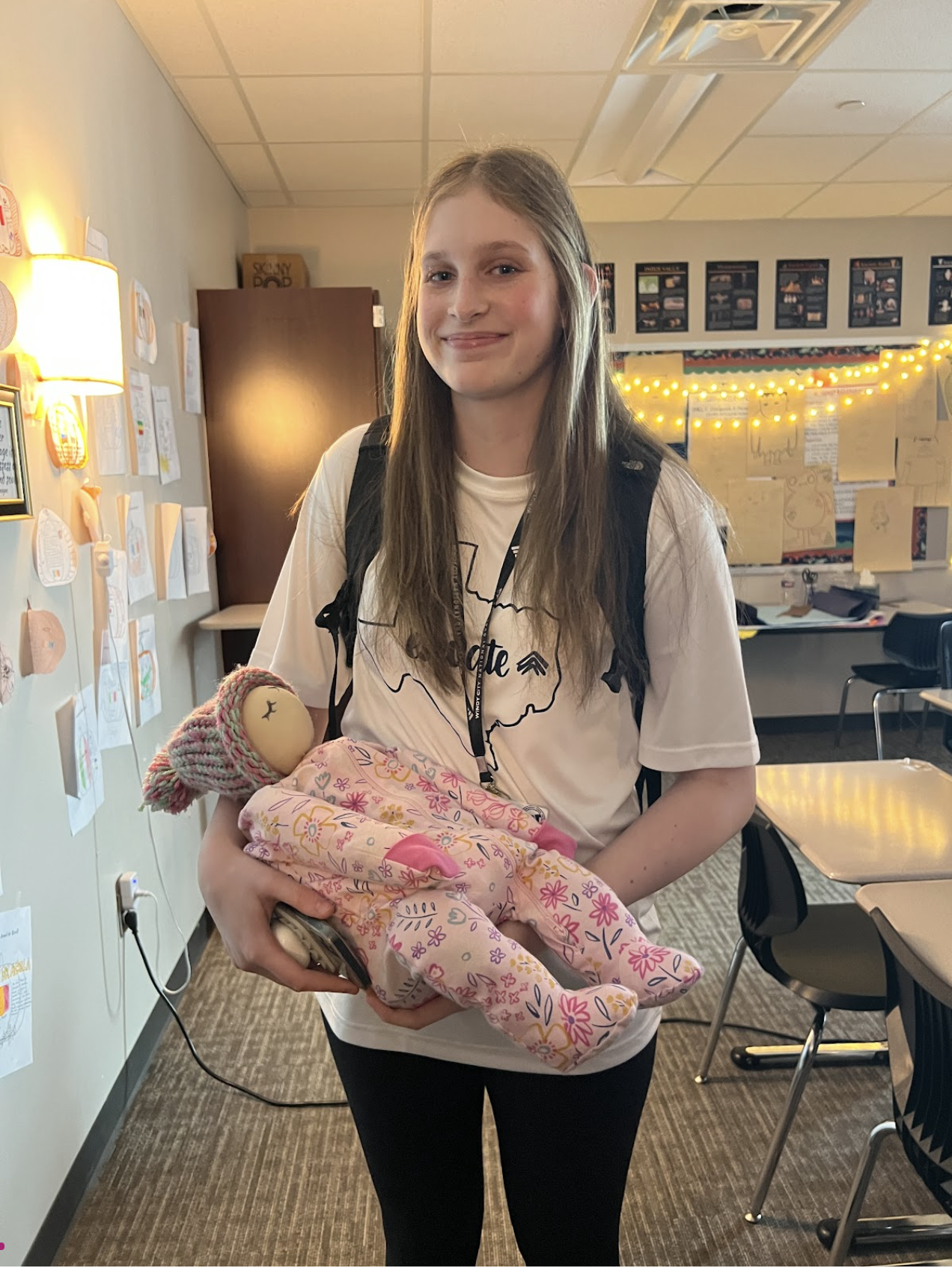 Oh Baby! \\Sophomore Emma Ball holds her flour baby in her AP World History class. This project consists of taking care of a fake baby for a week. “My baby’s name is Michelle, named after my mom and my middle name,” said Ball.